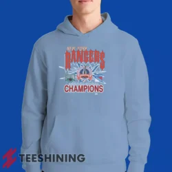 Male model showcasing the 1994 New York Rangers Eastern Conference Champions Classic Hockey Men's Hoodie in light blue. This ultra-cozy pullover hoodie is designed for warmth and everyday versatility.