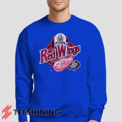Male model lounging in the 90s Detroit Red Wings Western Conference Champs Vintage Hockey Fan Men's Sweatshirt in royal blue. Made from ultra-soft fabric for unmatched comfort.