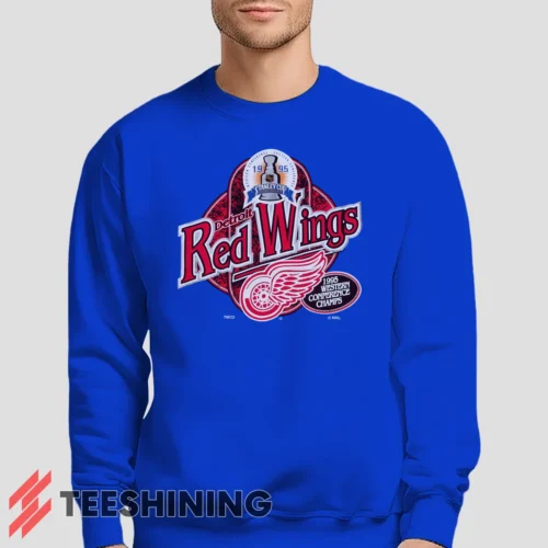 Male model lounging in the 90s Detroit Red Wings Western Conference Champs Vintage Hockey Fan Men's Sweatshirt in royal blue. Made from ultra-soft fabric for unmatched comfort.