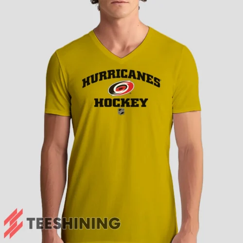 Male model rocking the Carolina Hurricanes NHL Hockey Men's V-Neck T-Shirt in yellow. Featuring a modern V-neck cut, perfect for a stylish yet casual look.