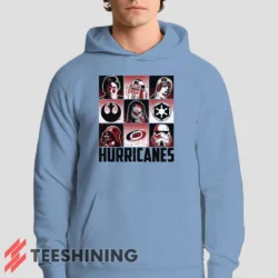 Male model showcasing the Carolina Hurricanes Star Wars Heroes And Villains Men's Hoodie in light blue. This ultra-cozy pullover hoodie is designed for warmth and everyday versatility.