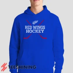 Male model showcasing the Detroit Red Wings Hockey Men's Hoodie in royal blue. This ultra-cozy pullover hoodie is designed for warmth and everyday versatility.
