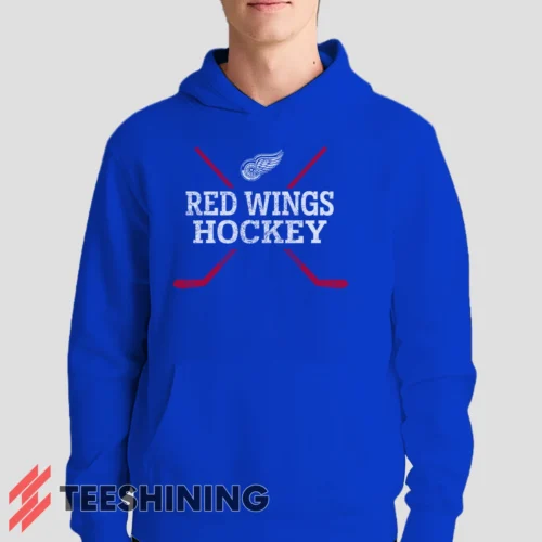 Male model showcasing the Detroit Red Wings Hockey Men's Hoodie in royal blue. This ultra-cozy pullover hoodie is designed for warmth and everyday versatility.