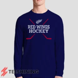 Male model sporting the Detroit Red Wings Hockey Men's Long Sleeve T-Shirt in navy. Lightweight and breathable, ideal for transitional weather.
