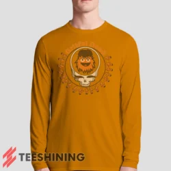 Male model sporting the Grateful Dead Gritty Philadelphia Flyers Men's Long Sleeve T-Shirt in orange. Lightweight and breathable, ideal for transitional weather.