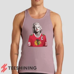 Male model wearing the Marilyn Monroe Chicago Blackhawks Unique Hockey Fan Men's Tank Top in light pink. A perfect blend of comfort and breathability for workouts or summer days.