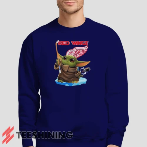 Male model lounging in the Star Wars Baby Yoda Detroit Red Wings Fun NHL Sci - Fi Fan Men's Sweatshirt in navy. Made from ultra-soft fabric for unmatched comfort.