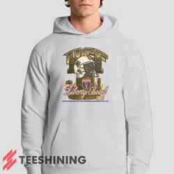 Male model showcasing the UCF Golden Knights 2007 Liberty Bowl Men's Hoodie in white. This ultra-cozy pullover hoodie is designed for warmth and everyday versatility.