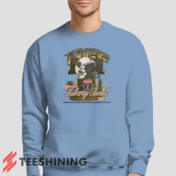 Male model lounging in the UCF Golden Knights 2007 Liberty Bowl Men's Sweatshirt in light blue. Made from ultra-soft fabric for unmatched comfort.