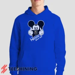 Male model showcasing the Vegas Golden Knights Haters Gonna Hate Mickey Mouse Disney Hockey Men's Hoodie in royal blue. This ultra-cozy pullover hoodie is designed for warmth and everyday versatility.