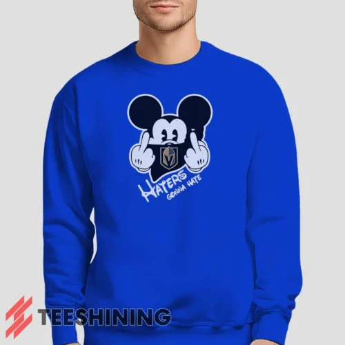 Male model lounging in the Vegas Golden Knights Haters Gonna Hate Mickey Mouse Disney Hockey Men's Sweatshirt in royal blue. Made from ultra-soft fabric for unmatched comfort.
