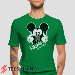 Male model wearing the Vegas Golden Knights Haters Gonna Hate Mickey Mouse Disney Hockey Men's T-Shirt in irish green. Crafted from ultra-soft cotton, this classic crew neck tee offers breathable comfort and effortless style.