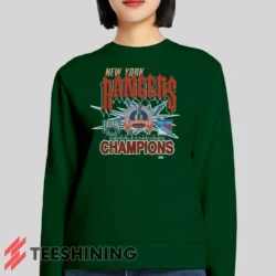 Female model lounging in the 1994 New York Rangers Eastern Conference Champions Classic Hockey Women's Sweatshirt in forest green. Made from ultra-soft fabric for unmatched comfort.