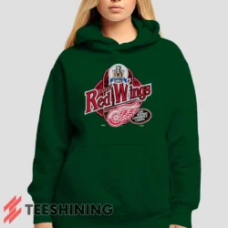 Female model showcasing the 90s Detroit Red Wings Western Conference Champs Vintage Hockey Fan Women's Hoodie in forest green. This ultra-cozy pullover hoodie is designed for warmth and everyday versatility.