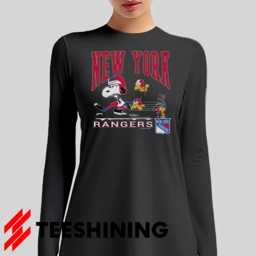 Female model sporting the 90s New York Rangers Snoopy Peanuts NHL Hockey Vintage Fan Women's Long Sleeve T-Shirt in charcoal. Lightweight and breathable, ideal for transitional weather.