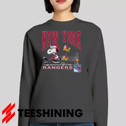 Female model lounging in the 90s New York Rangers Snoopy Peanuts NHL Hockey Vintage Fan Women's Sweatshirt in charcoal. Made from ultra-soft fabric for unmatched comfort.