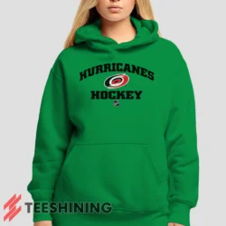 Female model showcasing the Carolina Hurricanes NHL Hockey Women's Hoodie in irish green. This ultra-cozy pullover hoodie is designed for warmth and everyday versatility.