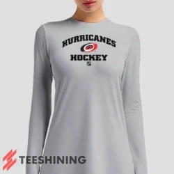 Female model sporting the Carolina Hurricanes NHL Hockey Women's Long Sleeve T-Shirt in white. Lightweight and breathable, ideal for transitional weather.