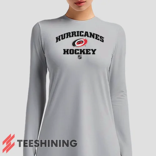 Female model sporting the Carolina Hurricanes NHL Hockey Women's Long Sleeve T-Shirt in white. Lightweight and breathable, ideal for transitional weather.