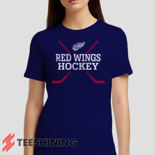Female model wearing the Detroit Red Wings Hockey Women's T-Shirt in navy. Crafted from ultra-soft cotton, this classic crew neck tee offers breathable comfort and effortless style.