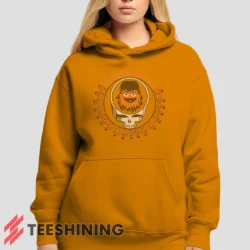 Female model showcasing the Grateful Dead Gritty Philadelphia Flyers Women's Hoodie in orange. This ultra-cozy pullover hoodie is designed for warmth and everyday versatility.