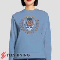 Female model lounging in the Grateful Dead Gritty Philadelphia Flyers Women's Sweatshirt in light blue. Made from ultra-soft fabric for unmatched comfort.