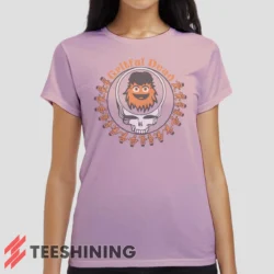 Female model wearing the Grateful Dead Gritty Philadelphia Flyers Women's T-Shirt in light pink. Crafted from ultra-soft cotton, this classic crew neck tee offers breathable comfort and effortless style.