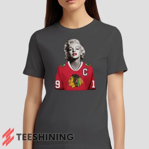 Female model wearing the Marilyn Monroe Chicago Blackhawks Unique Hockey Fan Women's T-Shirt in charcoal. Crafted from ultra-soft cotton, this classic crew neck tee offers breathable comfort and effortless style.