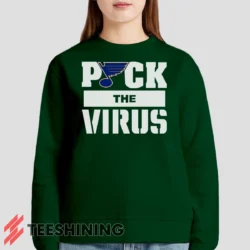 Female model lounging in the St Louis Blues Jets Puck The Virus Women's Sweatshirt in forest green. Made from ultra-soft fabric for unmatched comfort.